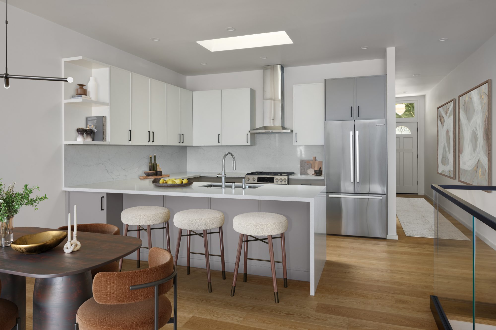 Modern kitchen with white flat-front cabinets, quartz island, and boucle barstools